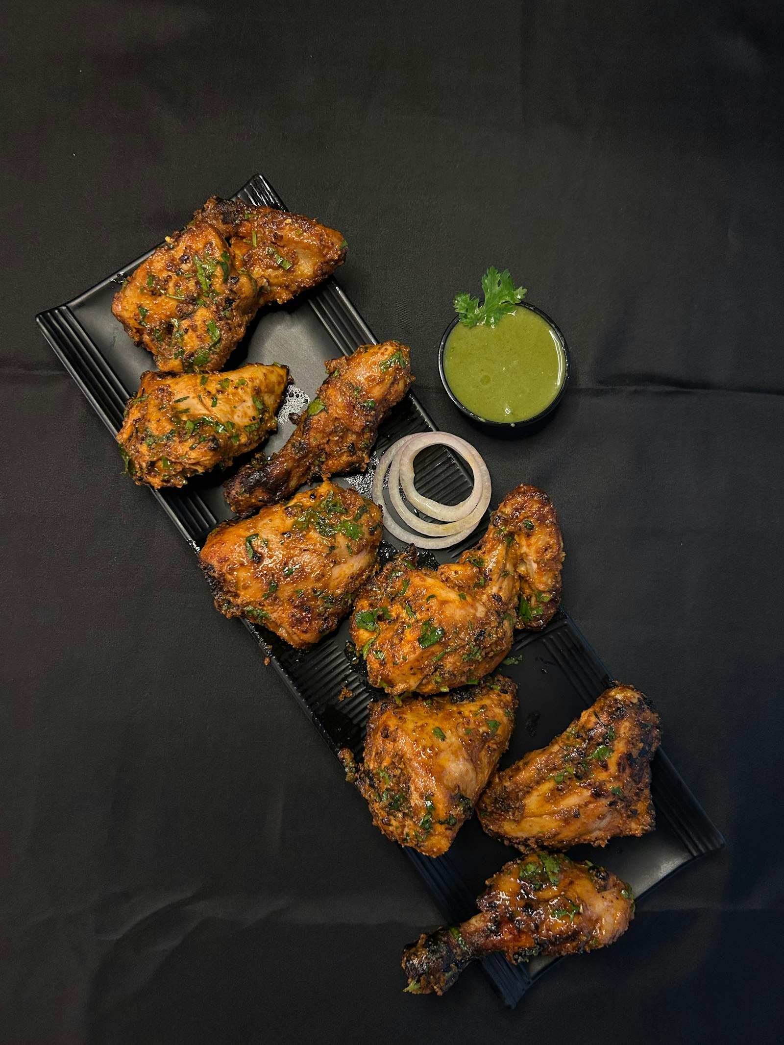 Grilled chicken served with herbs and dipping sauce